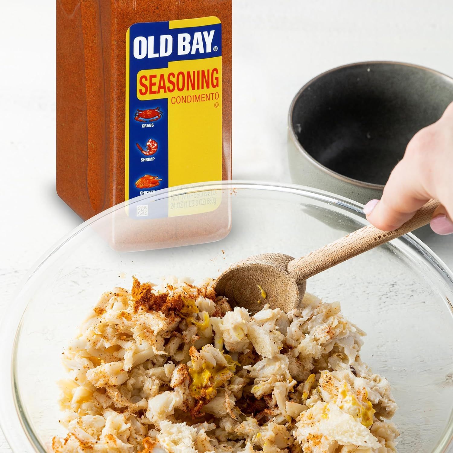 Demonstrates how to use Old Bay seasoning in a recipe by showing the product being mixed with crab meat, teaching shoppers a simple preparation method. Shows the product in action with a real food…
