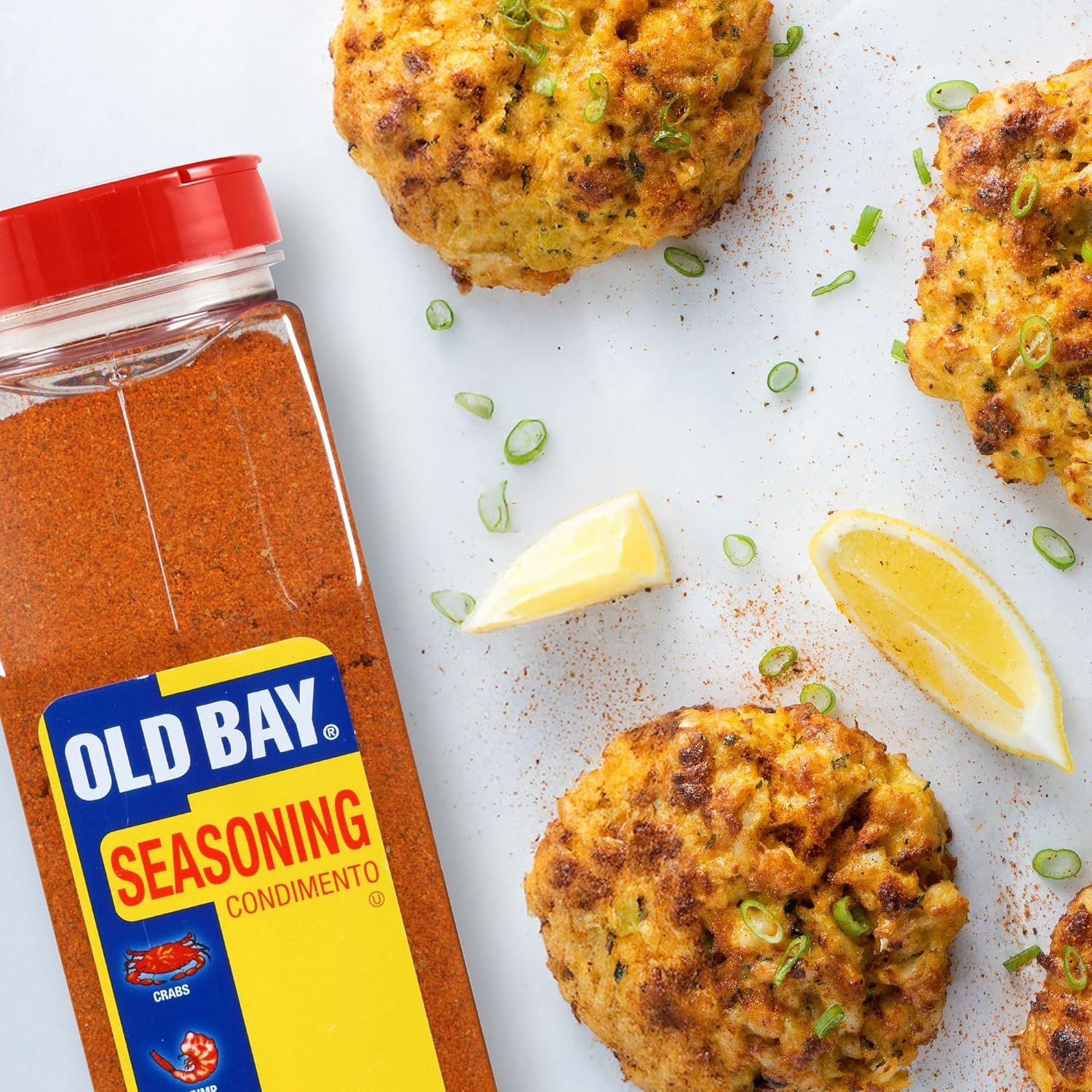 Demonstrates the product in a real-world culinary context, showing the seasoning used with prepared crab cakes to inspire usage and showcase the product's application in cooking.