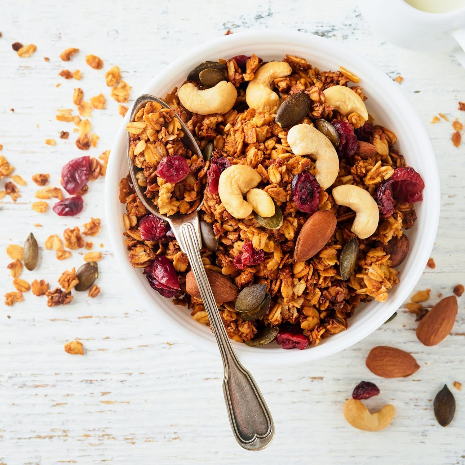 Shows the granola product in an appetizing, real-world context to help shoppers visualize the product as part of their daily routine and lifestyle.