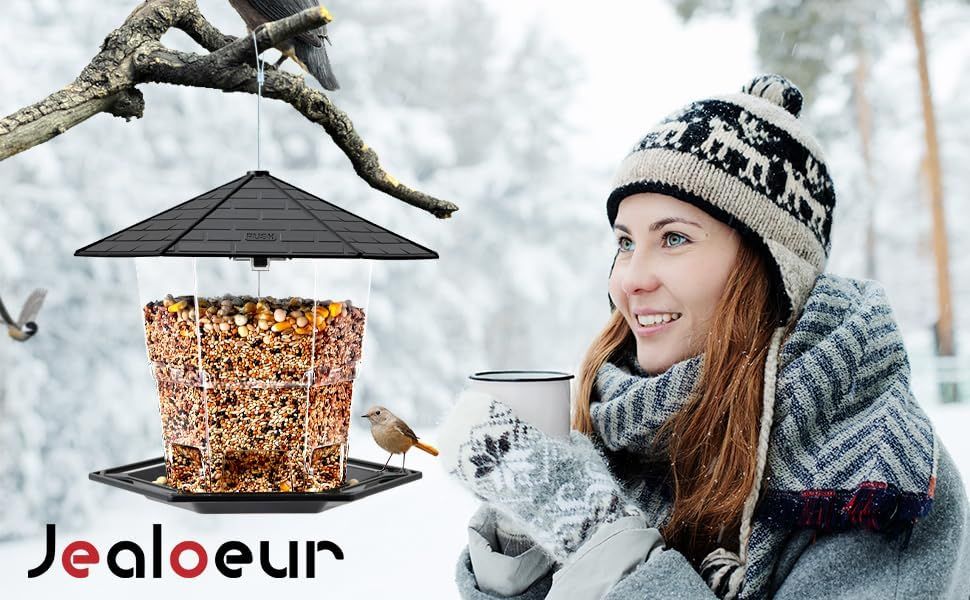 Demonstrates the product being used in a real-world winter setting to help shoppers visualize the bird feeder in their own outdoor environment and connect emotionally with the product.