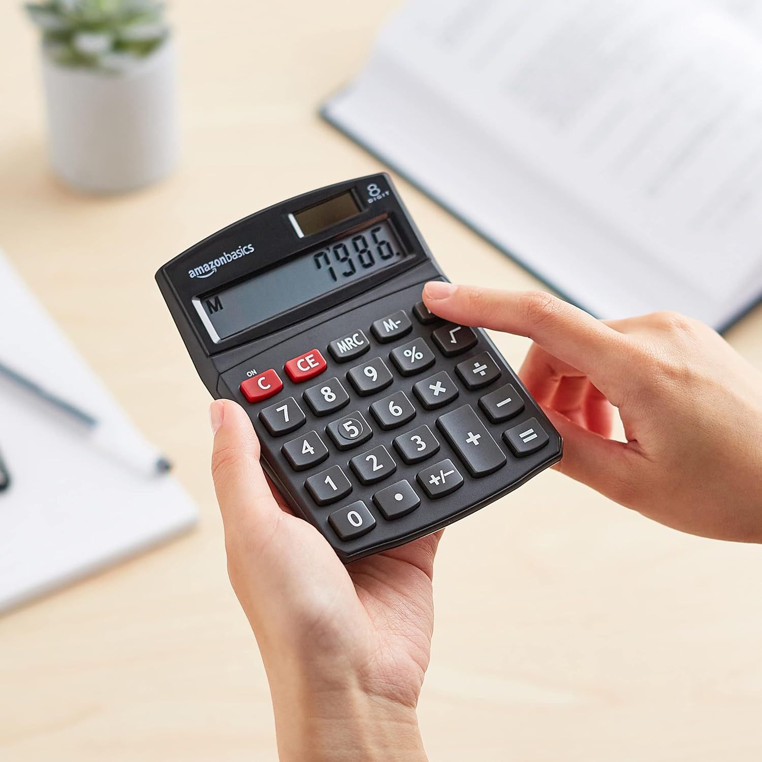 Shows the calculator being used in a real-world office or home setting to help shoppers visualize the product in everyday use.