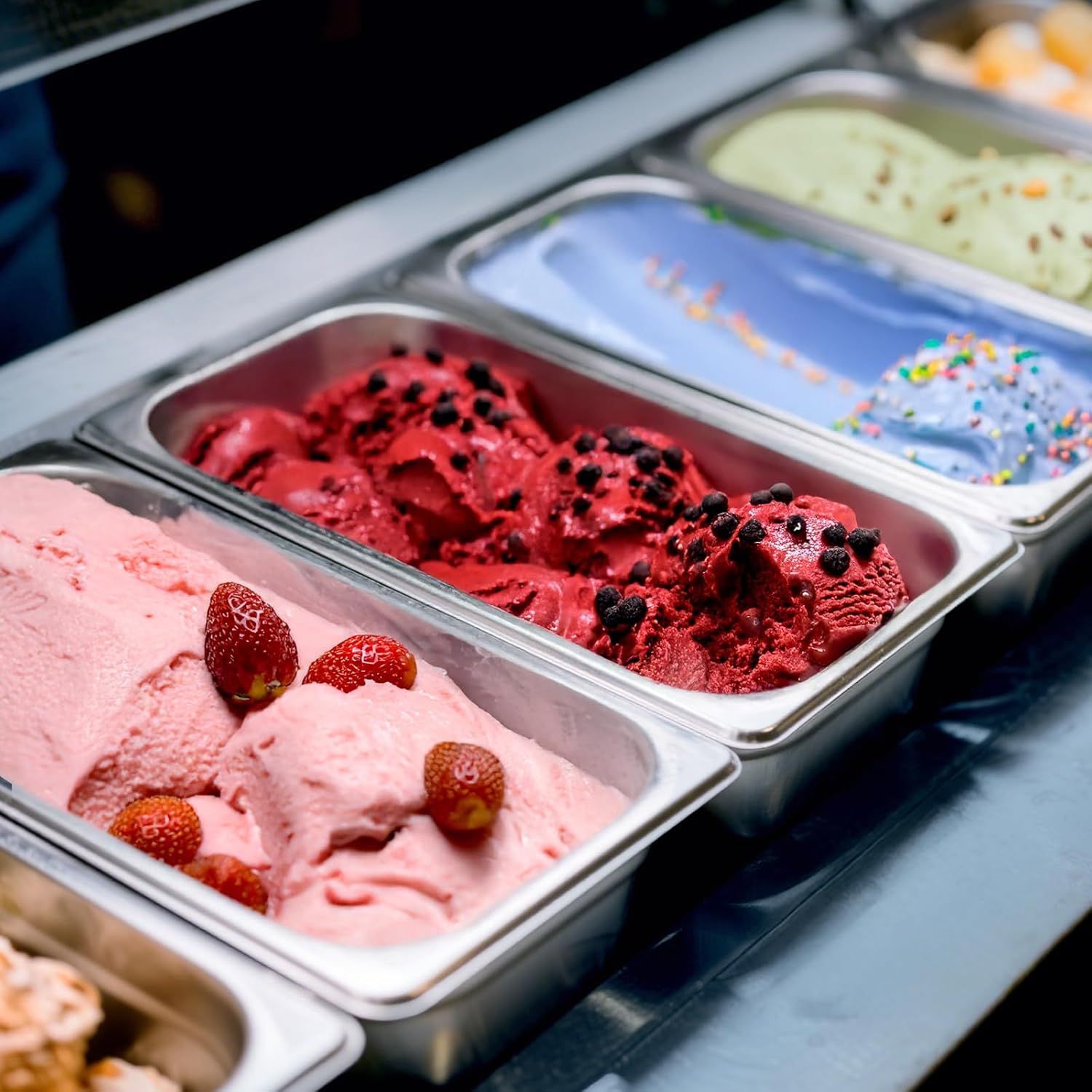 Shows the product (ice cream) in an authentic, real-world context at what appears to be an ice cream shop or display case, helping shoppers visualize the product as it would appear when served or…