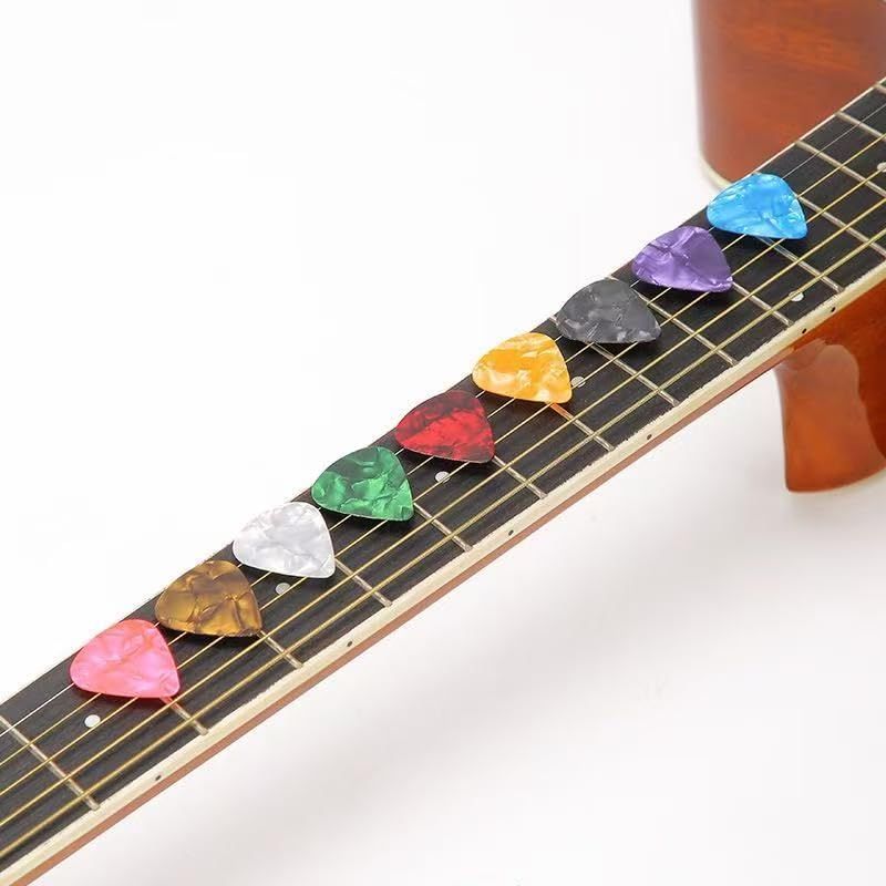 Shows the variety of colorful guitar picks included with the product, demonstrating the value and options the customer receives. Displays the range of color options available in the product line,…