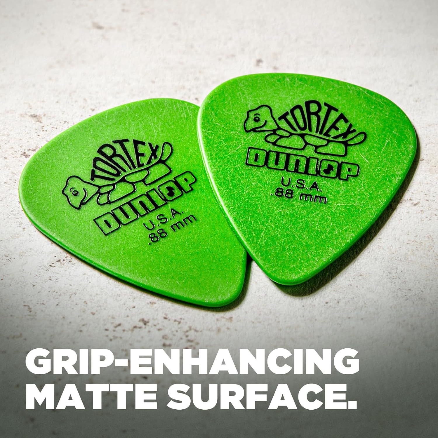Highlights the matte surface texture of the guitar picks to communicate improved grip and control during playing.