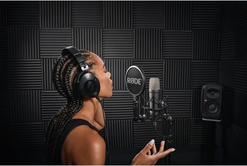 Demonstrates the product in a real-world professional recording studio setting to help shoppers visualize the microphone's use in high-quality audio production contexts.
