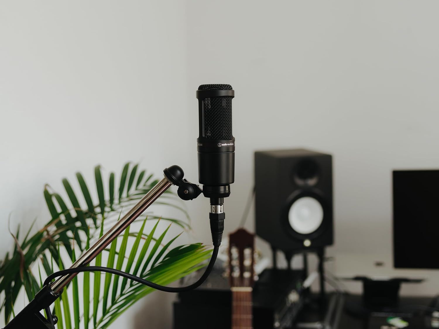Showcases the microphone in a real-world recording studio setting to help shoppers visualize the product in use and understand its professional audio application.