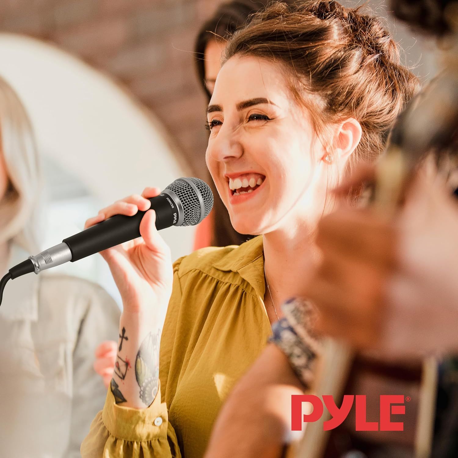 Shows the product (microphone) being used in a real-world social setting to help shoppers visualize themselves using it at parties, karaoke nights, or gatherings with friends.