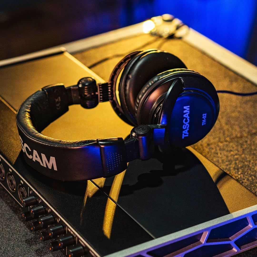 Showcases the headphones in a real-world professional audio/gaming environment to help shoppers visualize the product in use and establish its premium positioning.