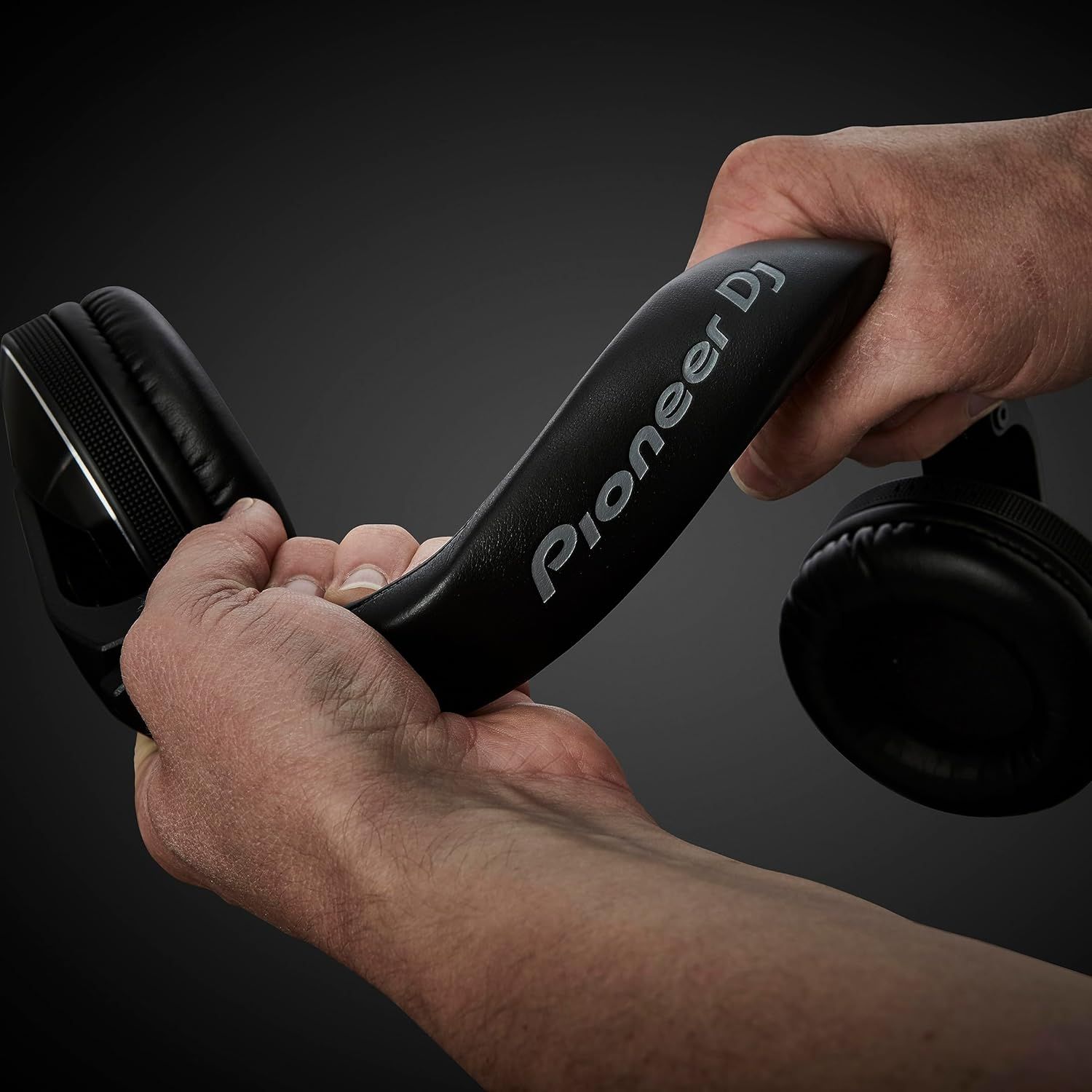 Demonstrates the product being used in a real-world DJ/audio professional context to help shoppers visualize how they would use the headphones.