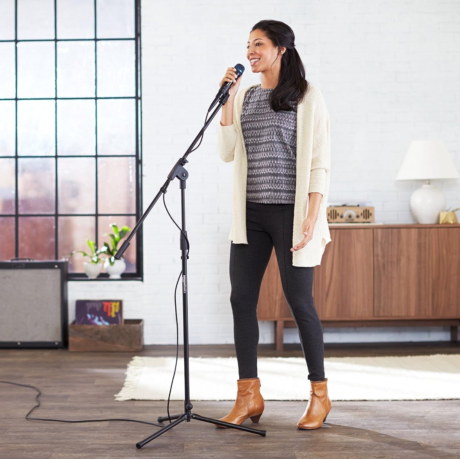 Demonstrates the product being used in a real-world home setting to help shoppers visualize the microphone in their own space and understand its practical application.