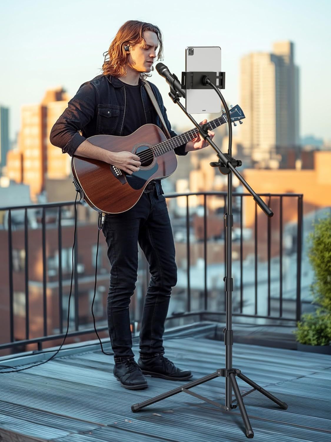 Demonstrates the product in a real-world use case, showing a musician using the microphone and tablet stand setup for outdoor recording or live streaming on a rooftop, emphasizing versatility and…