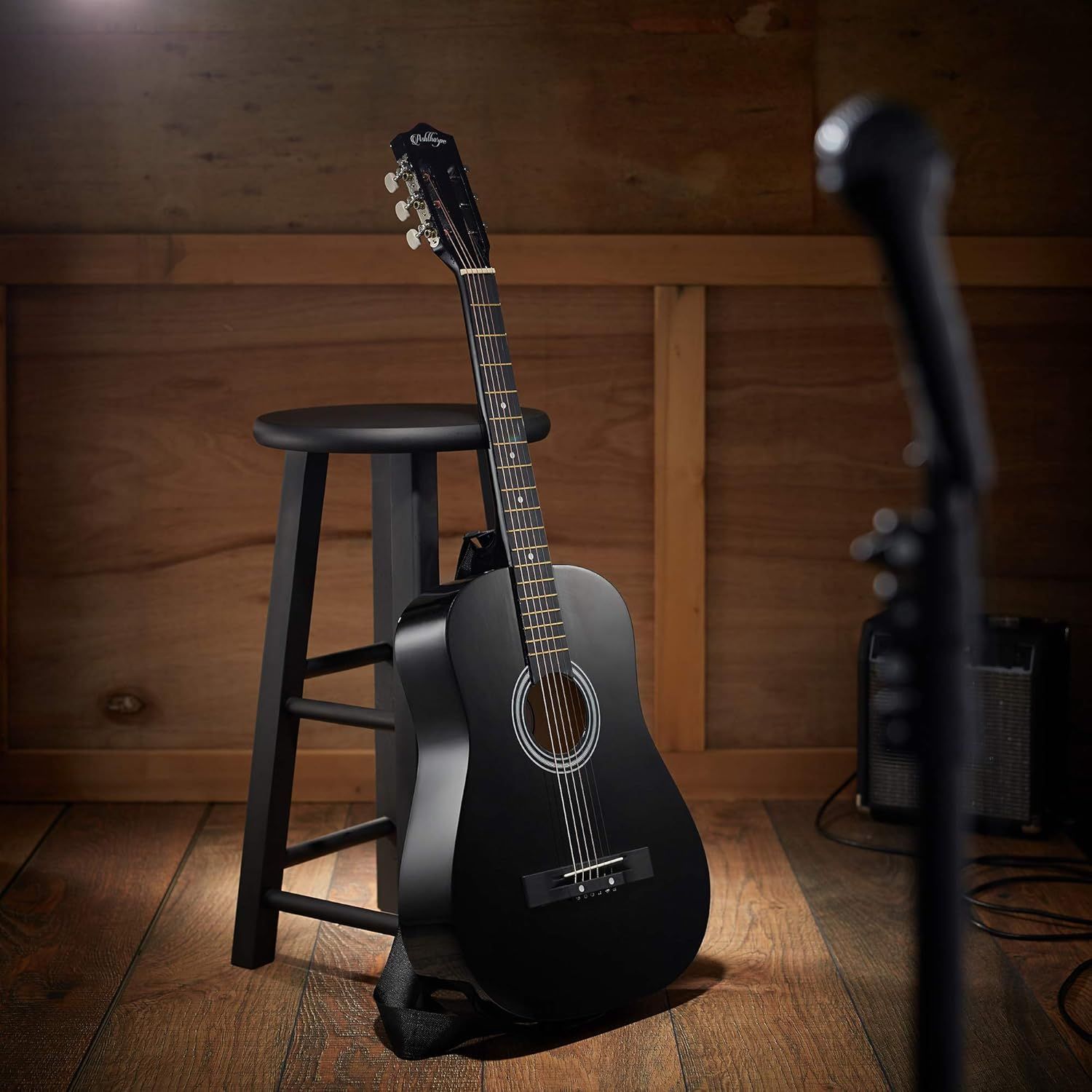 Showcases the guitar in an authentic lifestyle setting to help shoppers visualize the product in a real-world music or home studio context.