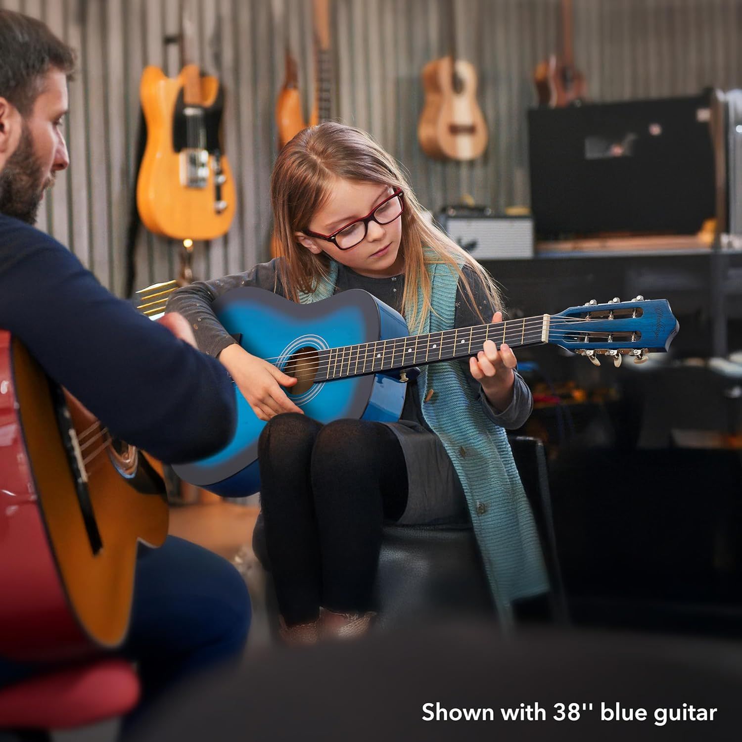 Demonstrates the physical size of the guitar (38 inches) in a real-world context with a child user, helping shoppers understand the scale and suitability for younger or beginner players.