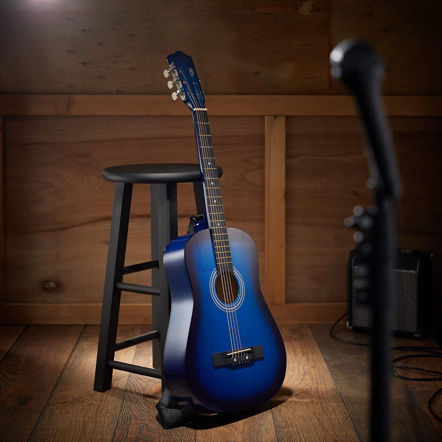 Showcases the guitar in an authentic lifestyle environment to help shoppers visualize the product in a real-world musical setting.