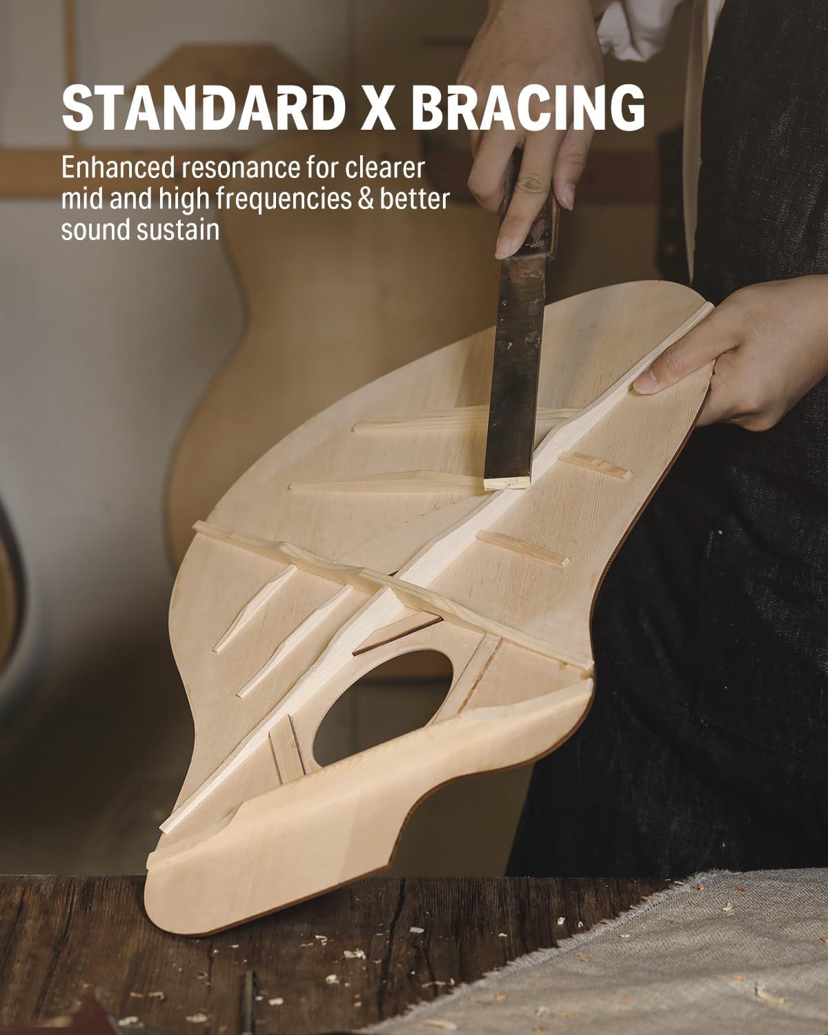 Highlights the internal structural component (X bracing) of the guitar to communicate enhanced sound quality and resonance, reassuring shoppers of superior craftsmanship and acoustic performance.…