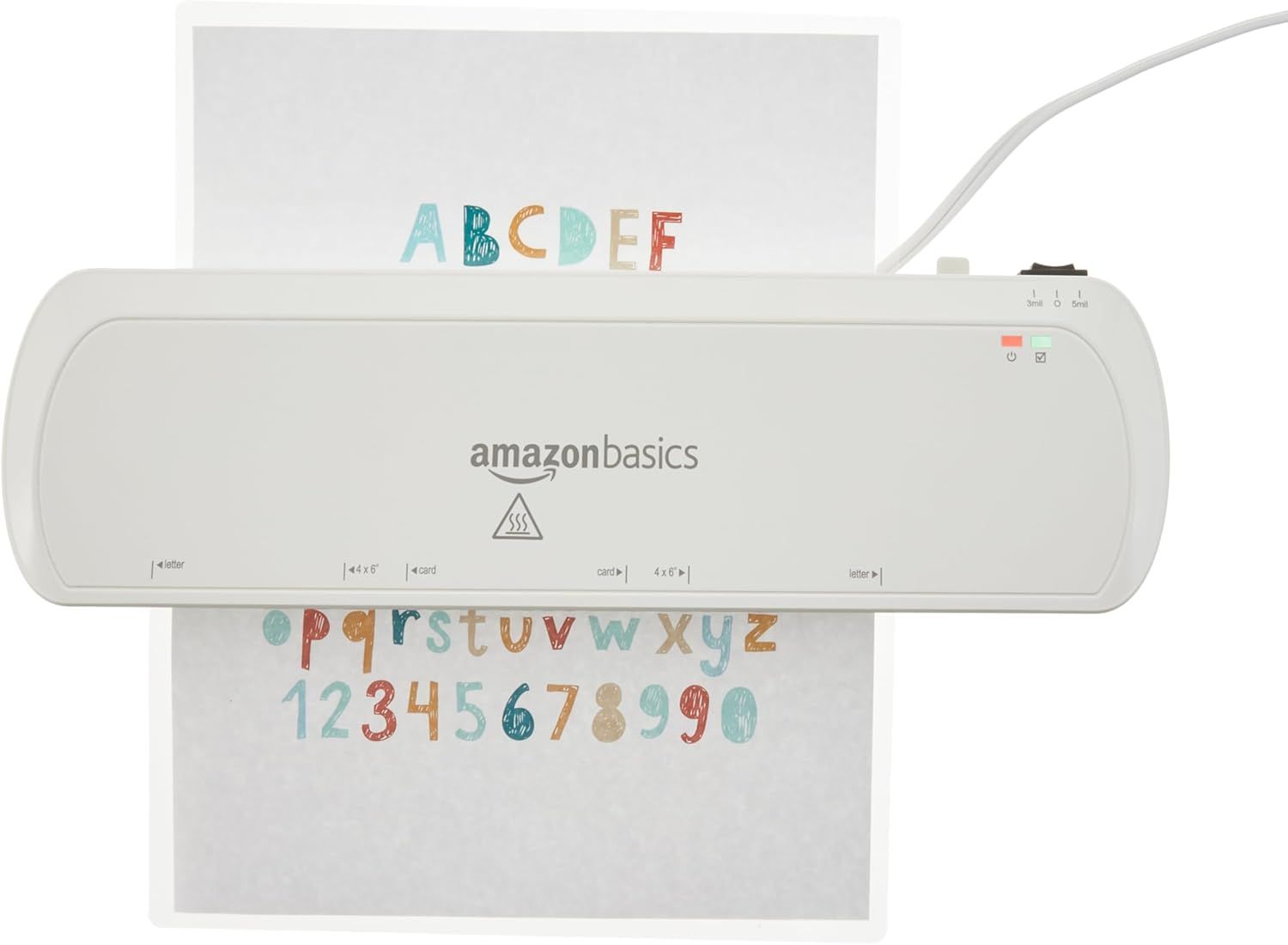 Shows the AmazonBasics laminator in use with a colorful alphabet and numbers sheet being laminated, demonstrating the product in action on a clean white background.