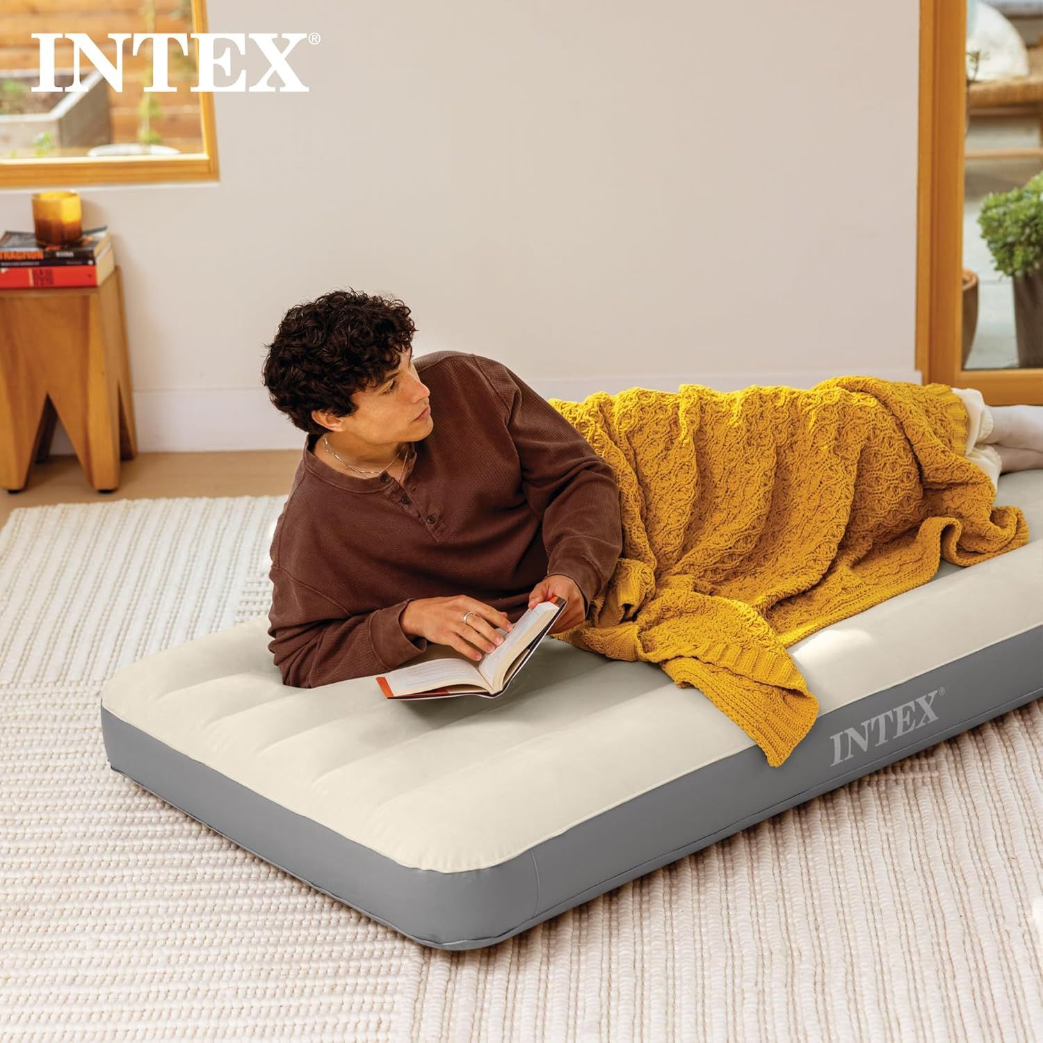 Demonstrates the product in a real-world home setting to help shoppers visualize using the air mattress for everyday relaxation and comfort.