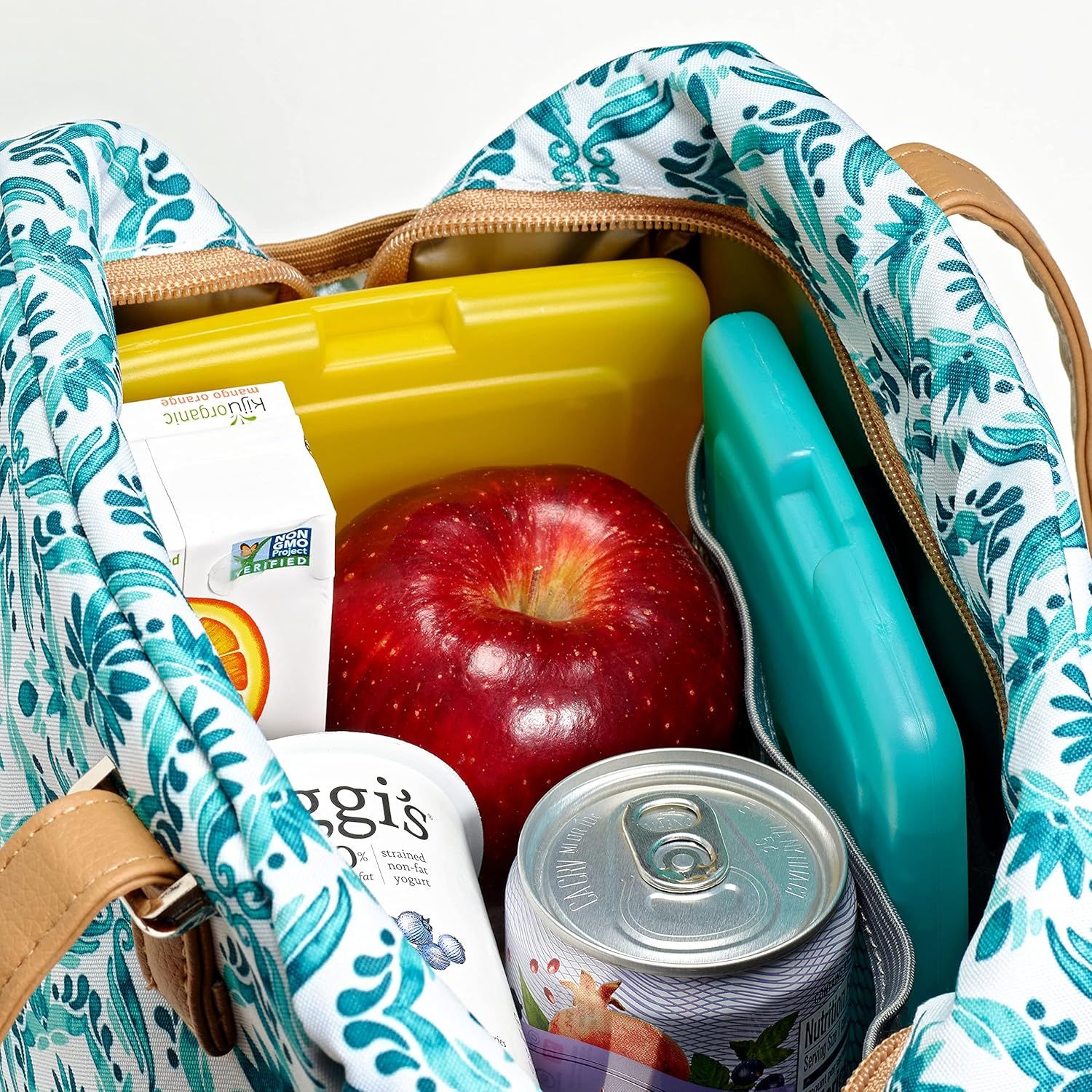 Demonstrates what the lunch bag can hold and how it organizes various food items and containers, showing its practical capacity and versatility for meal prep.
