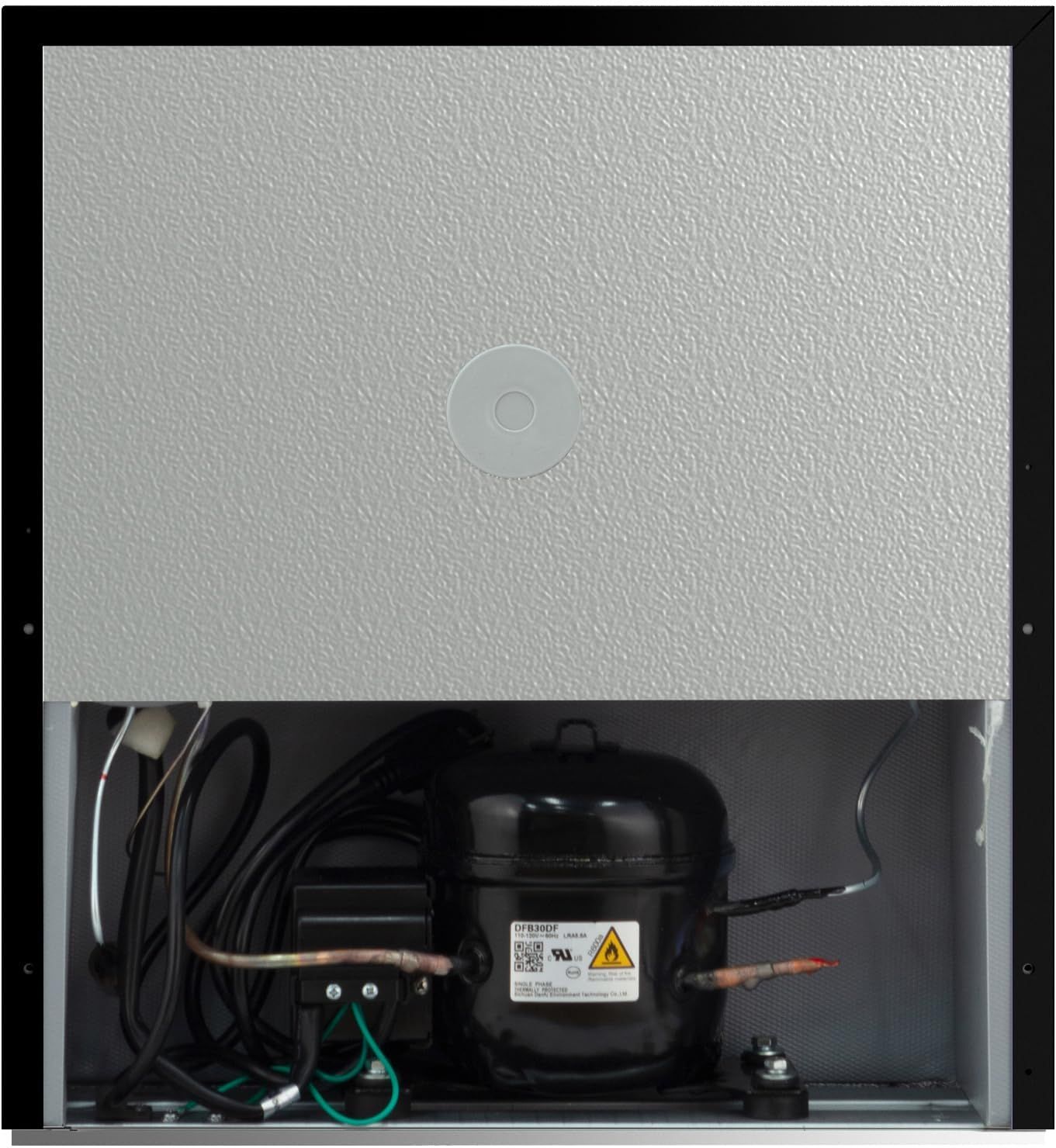 Shows the internal mechanical components and compressor motor to demonstrate the product's construction quality and help shoppers understand what powers the unit.