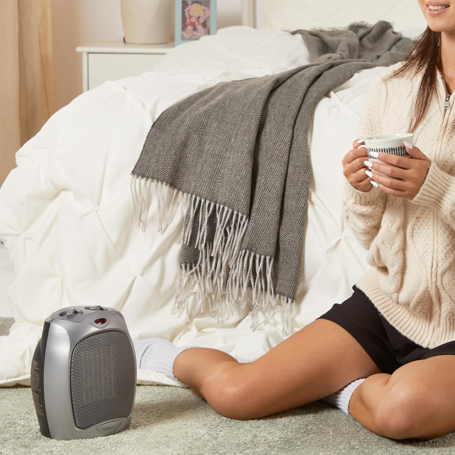 Demonstrates the product in a real-world bedroom setting to help shoppers visualize using the space heater in their own home for comfort and warmth.