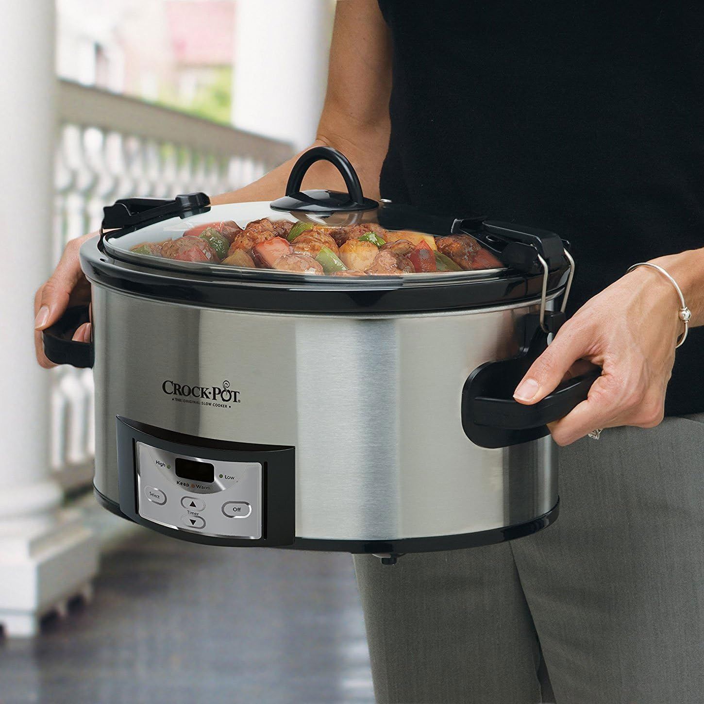 Demonstrates the product's portability and ease of carrying with secure handles, showing it in a real-world kitchen context to help shoppers visualize using it in their own homes.