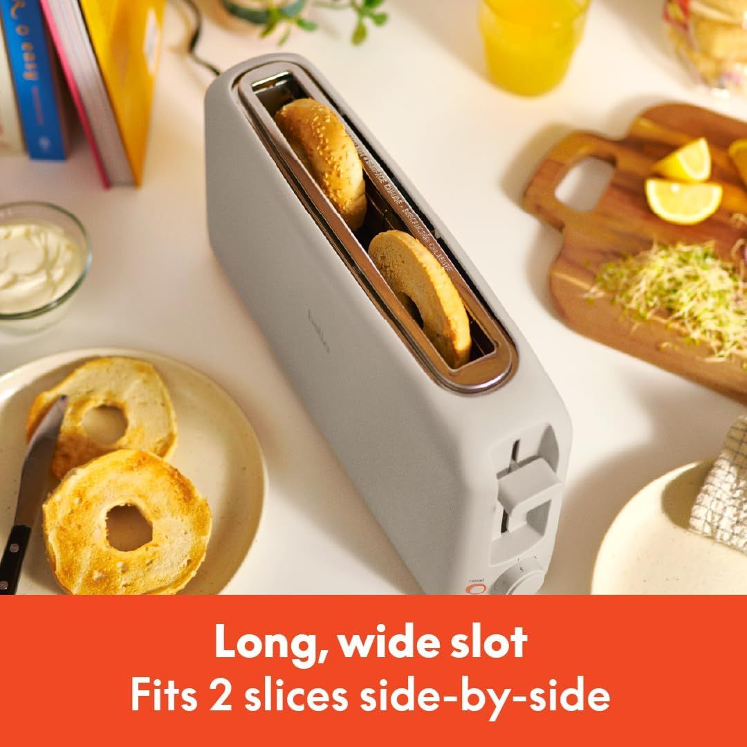 Communicates the toaster's ability to accommodate 2 slices side-by-side in a long, wide slot, highlighting its capacity and convenience for toasting multiple items at once. Demonstrates the…