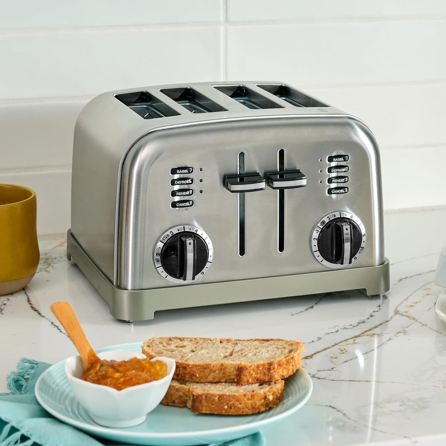 Shows the toaster in a real-world kitchen setting with breakfast items to help shoppers visualize the product in their daily routine.