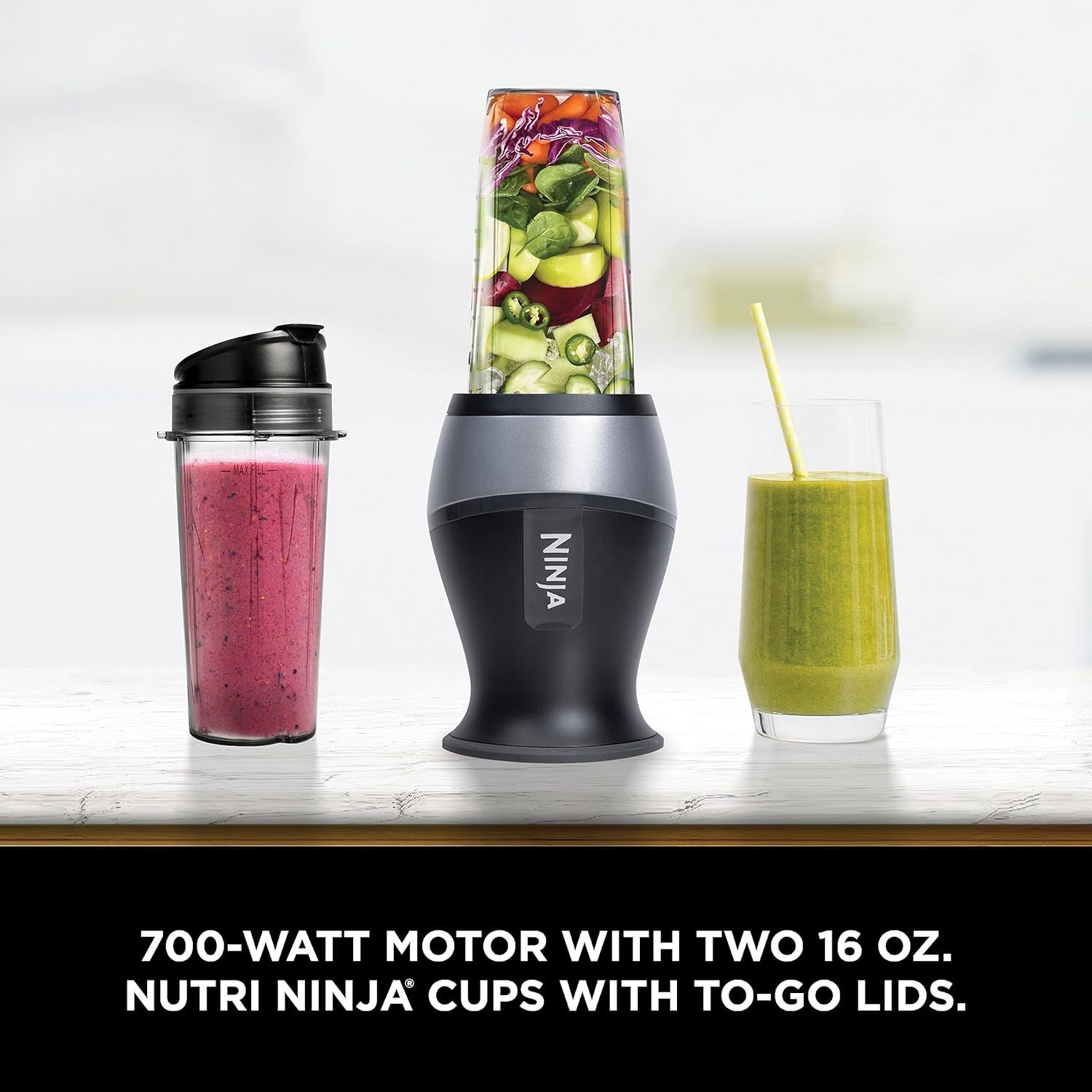 Shows the complete package contents including the blender base, motor unit, and two portable cups with lids to communicate what the customer receives and emphasize the convenience of the to-go system.