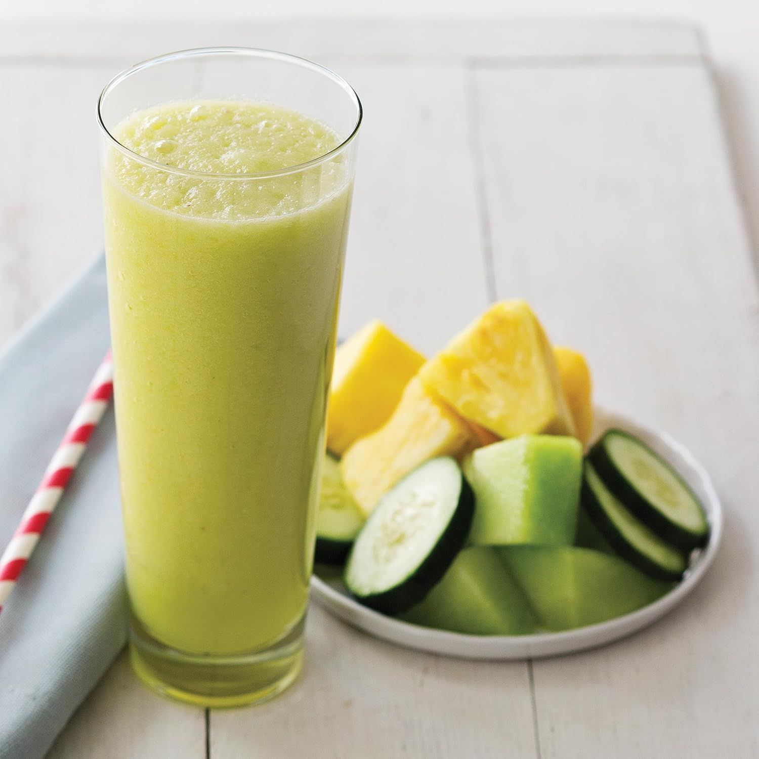Showcases the product (smoothie/juice) in an appealing, natural lifestyle setting with fresh ingredients to evoke health, freshness, and real-world usage.