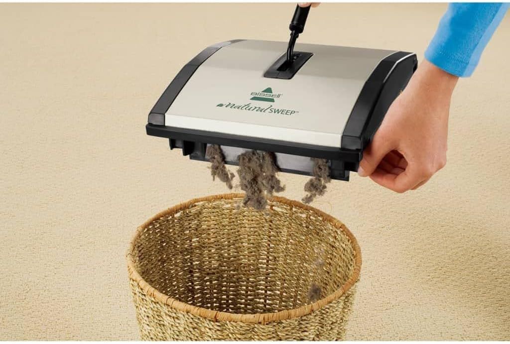 Demonstrates the product's ability to effectively pick up and collect dirt, dust, and debris from carpets, reassuring shoppers of its cleaning performance.