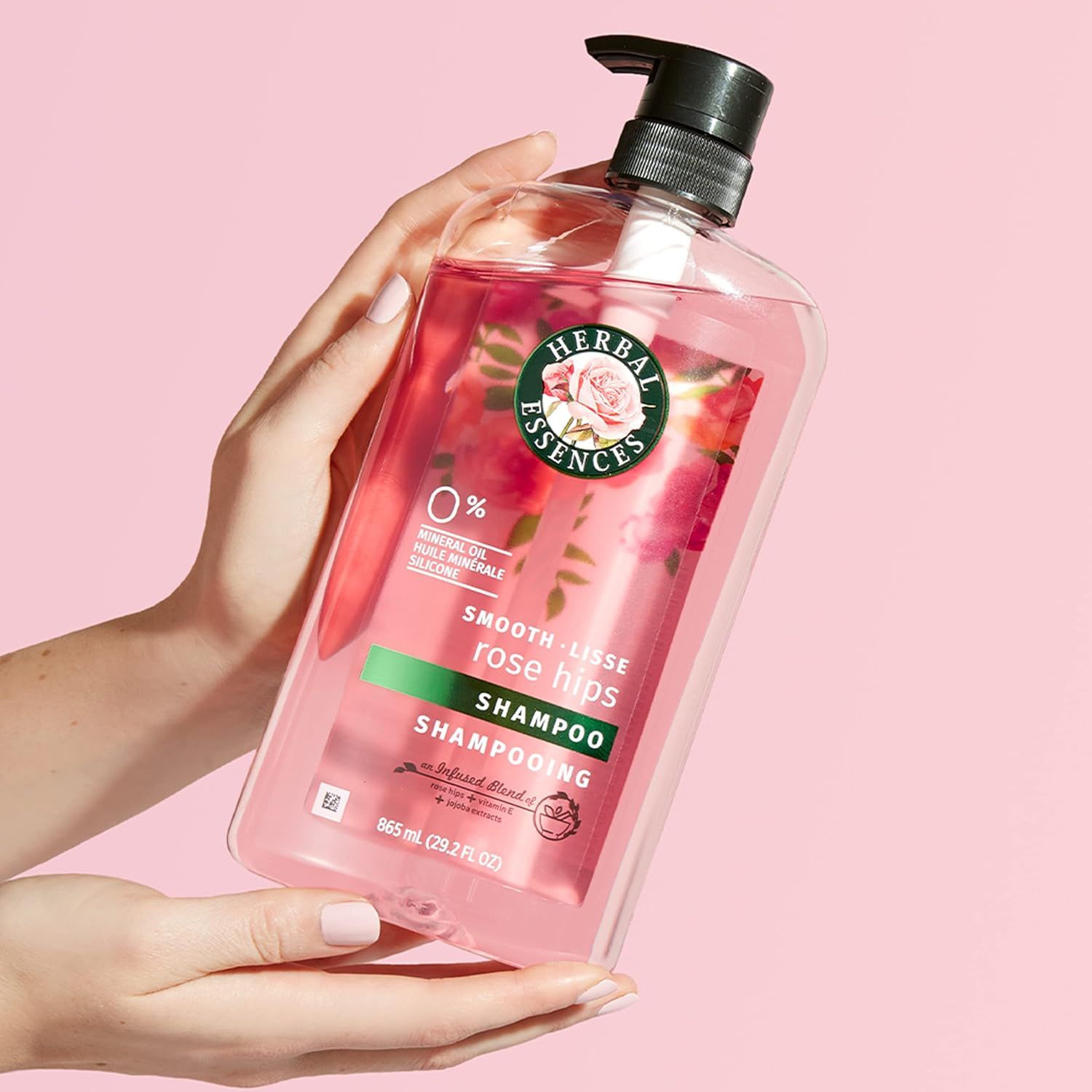 Shows the product in a real-world context being held by hands to help shoppers visualize the size, shape, and aesthetic appeal of the shampoo bottle.