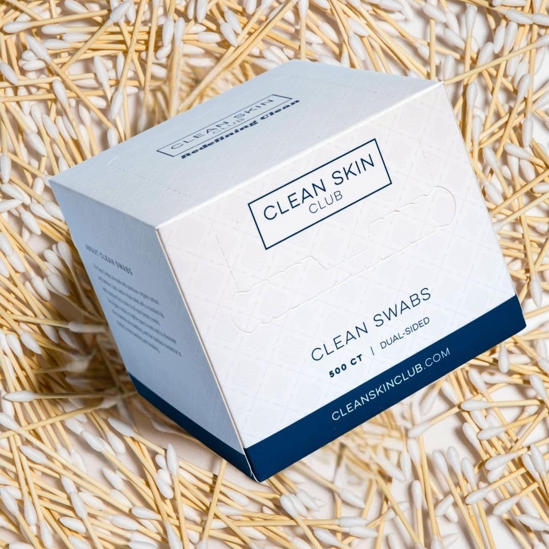 Displays the Clean Skin Club swabs product packaging in a clean, lifestyle setting to show the product as it would be received and to communicate the brand's aesthetic.