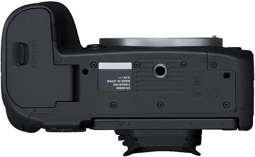 Provides a clean catalog-style view of the camera's bottom surface, showing the physical design, battery compartment, tripod mount, and regulatory markings without any distracting elements.