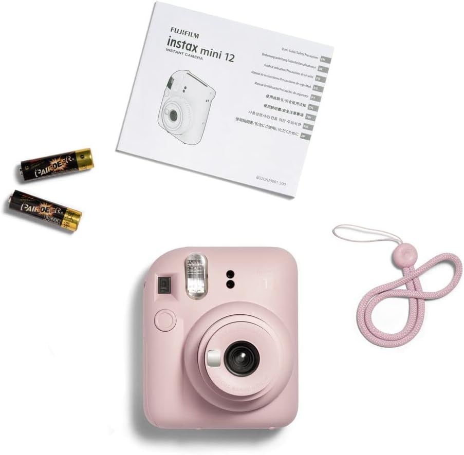 Shows everything included in the package: the Instax Mini 12 camera, instruction manual, batteries, and carrying strap, helping shoppers understand the full value of their purchase.