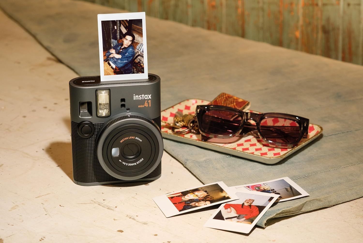 Showcases the product in a natural, aspirational lifestyle setting to help shoppers visualize how the instant camera fits into everyday moments and personal style.