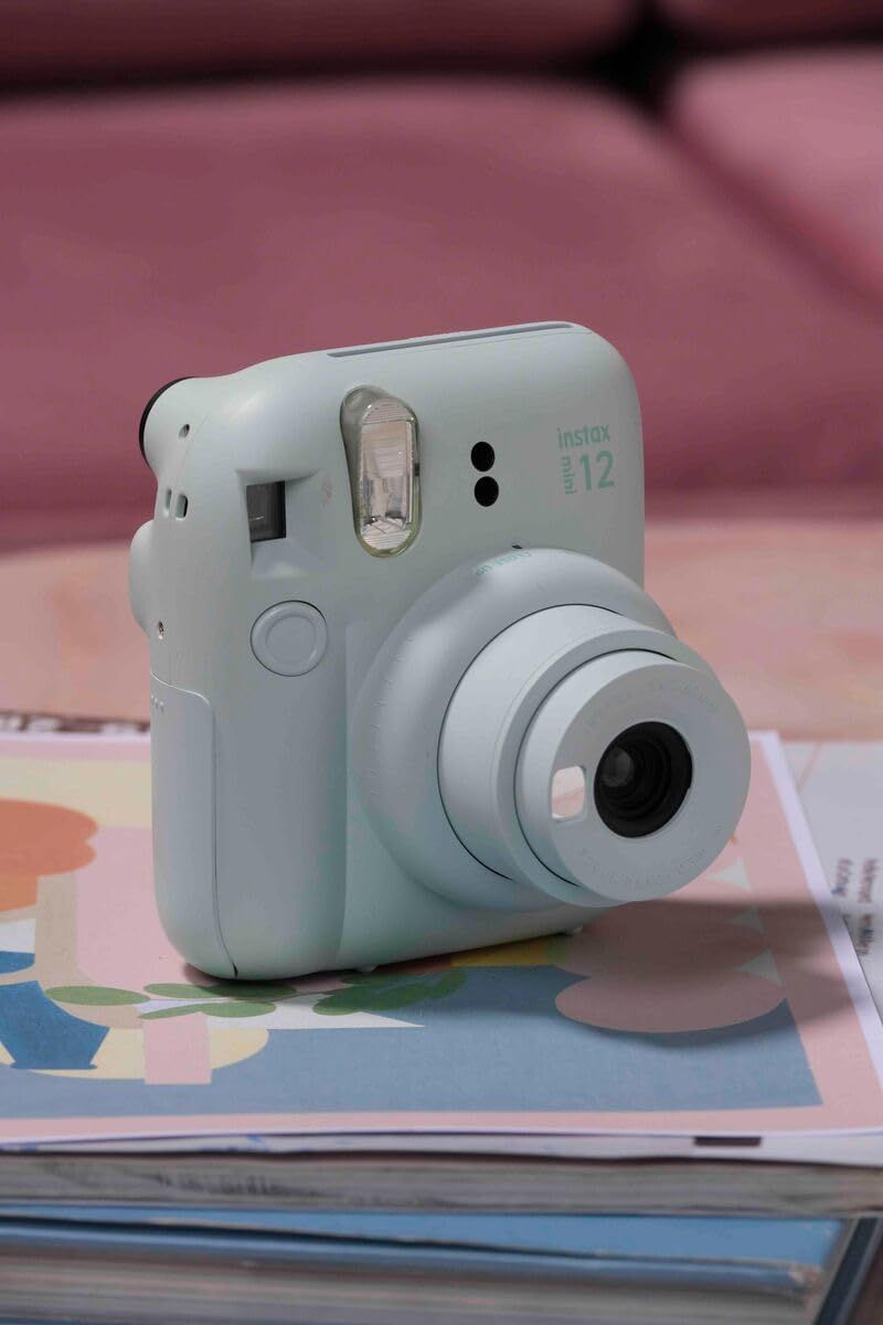 Shows the Instax Mini 12 camera in a natural lifestyle setting to help shoppers visualize the product in everyday use and create an emotional connection.