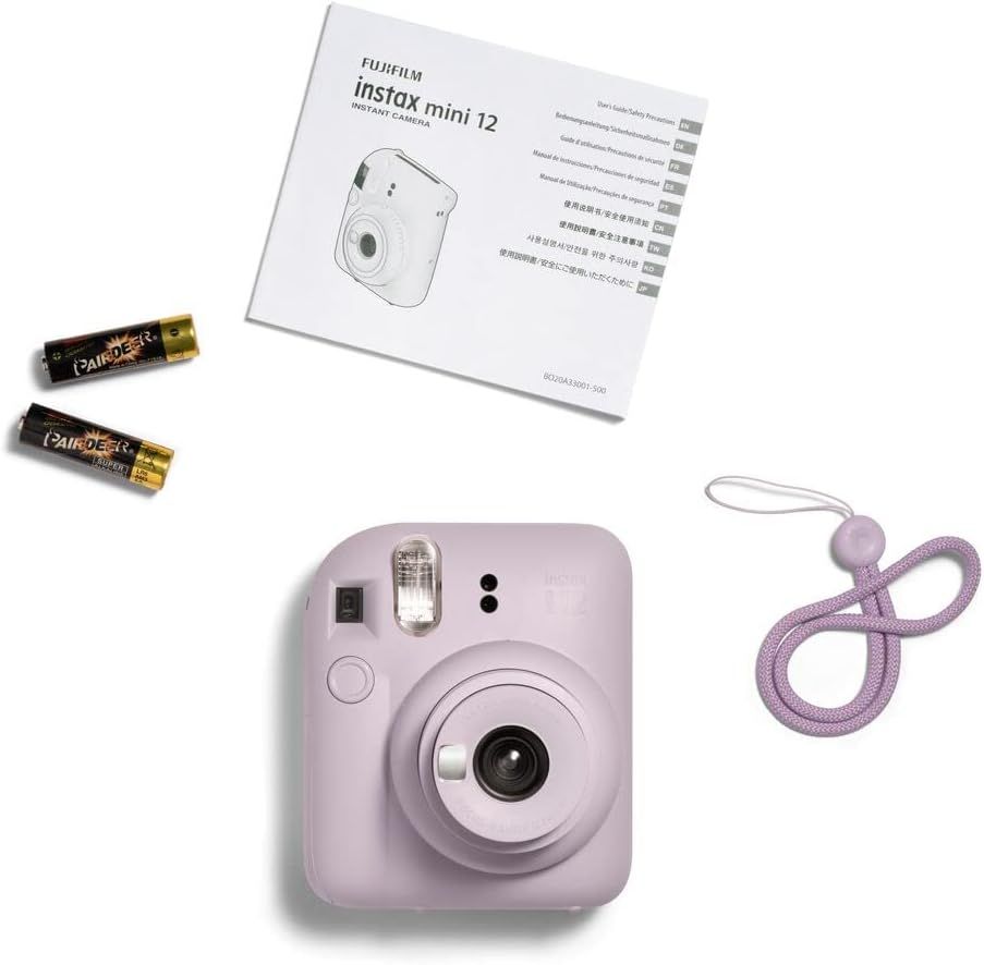Shows everything included in the package: the Instax Mini 12 camera, instruction manual, batteries, and carrying strap, reassuring shoppers they receive a complete ready-to-use kit.