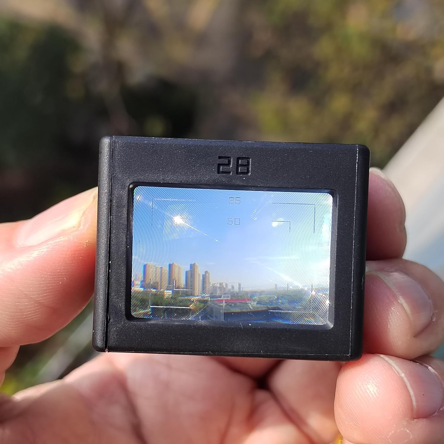 Demonstrates the ultra-compact, portable size of the device by showing it held in a hand, reassuring shoppers that it's small enough to carry anywhere.
