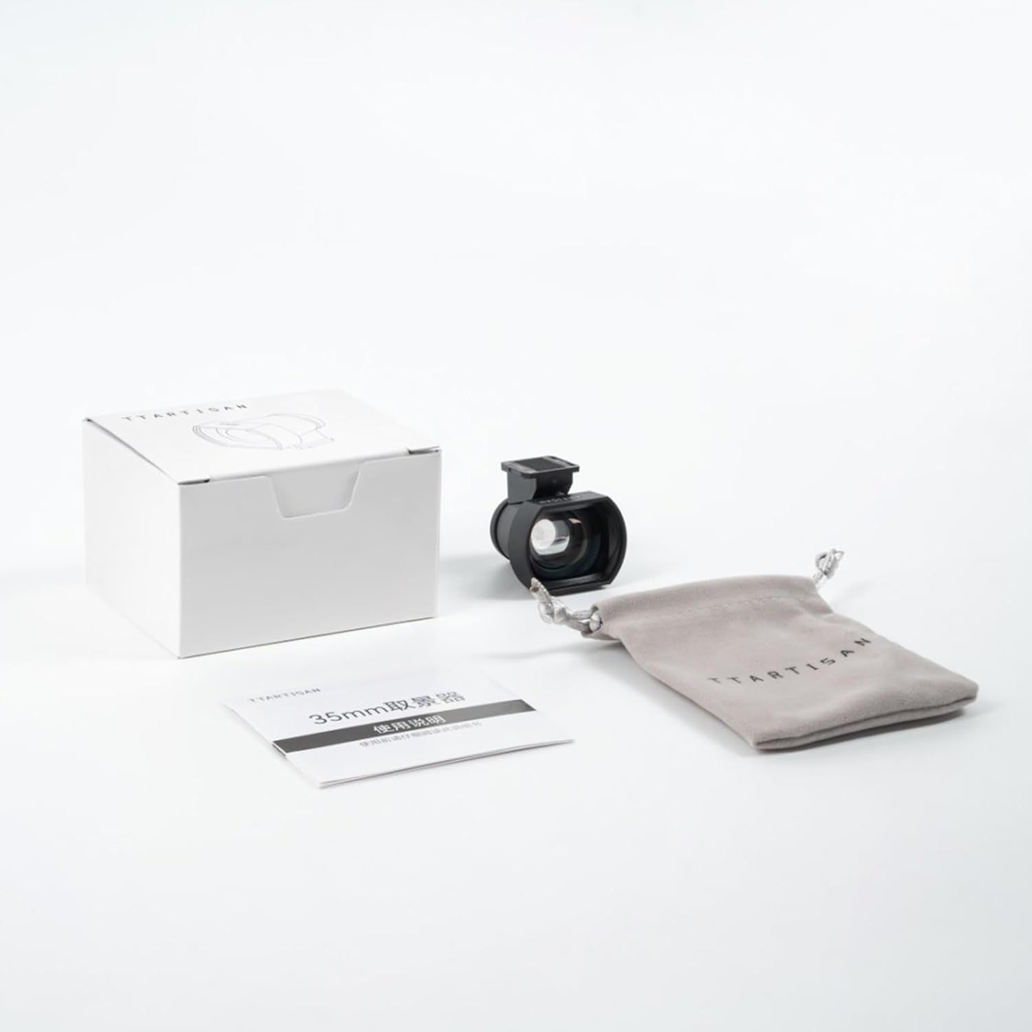Shows everything included in the purchase: the viewfinder accessory, protective pouch, instruction manual, and retail packaging to reassure shoppers they are getting a complete kit.