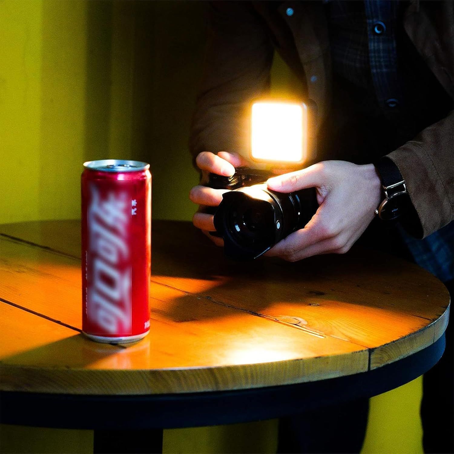 Demonstrates the small, portable size of the light by comparing it to a familiar reference object (soda can), reassuring shoppers that it's compact and easy to carry.