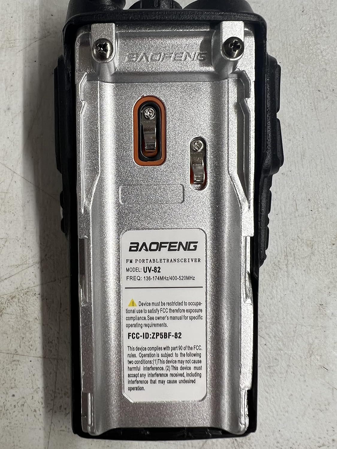 Shows the back of the product with brand name, model information, and regulatory compliance details to provide shoppers with technical specifications and certification information.