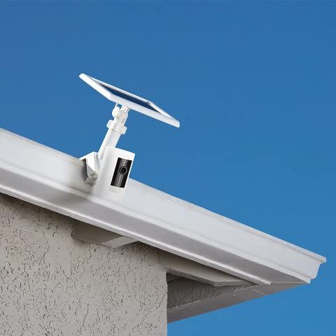 Demonstrates the product installed in a real-world outdoor setting to show shoppers how it looks when mounted on a home, emphasizing its solar panel and weatherproof design.
