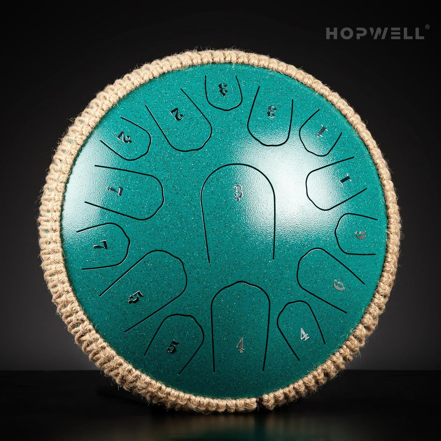 Displays the steel tongue drum product in a clean, catalog-style format to show its physical appearance, numbered tongues, rope edge detail, and turquoise finish without distractions.