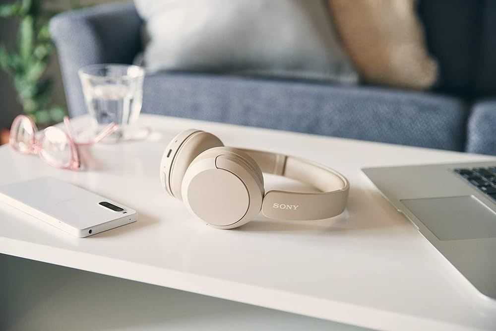 Demonstrates the product in a real-world home setting to help shoppers visualize how the headphones fit into their everyday lifestyle and living space.