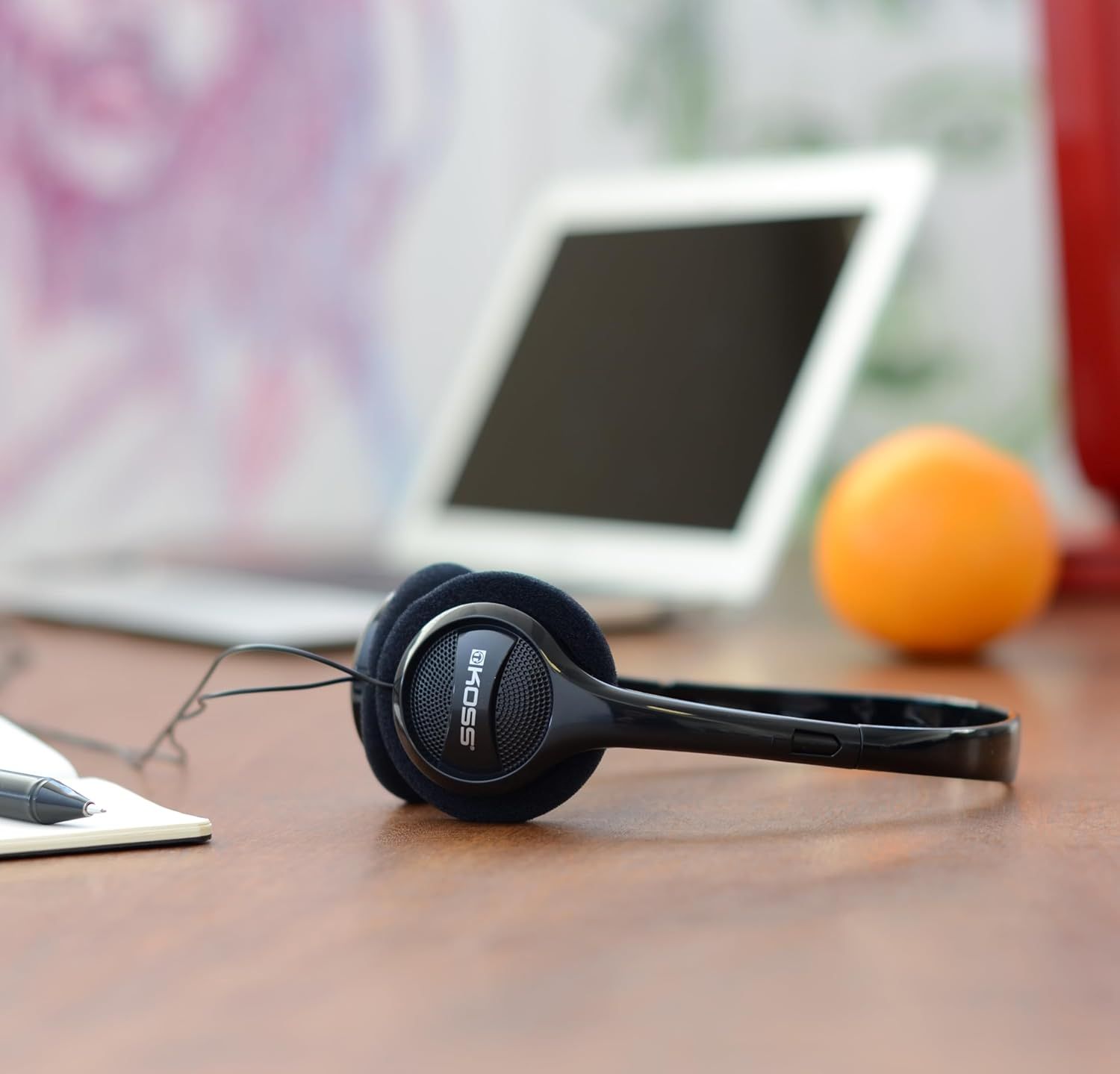 Shows the headphones in a real-world office or work-from-home setting to help shoppers visualize the product in their daily routine.