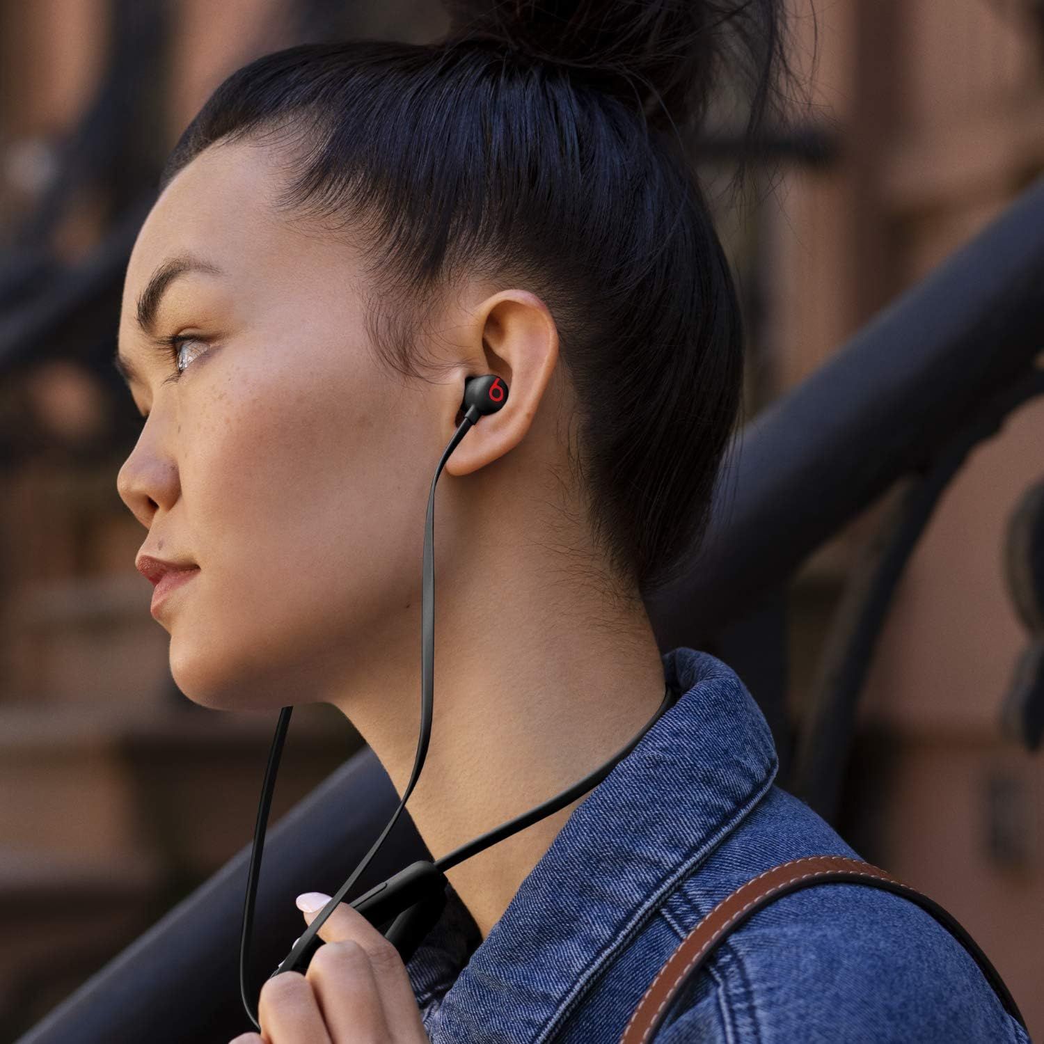 Demonstrates the product being worn in a natural, everyday environment to help shoppers visualize how the earbuds look and fit during actual use.