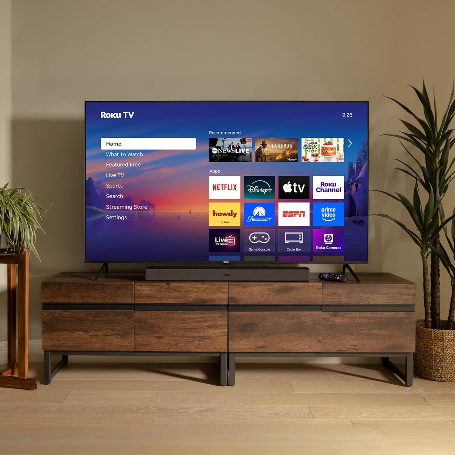 Demonstrates the product in a real-world living room environment to help shoppers visualize how the Roku TV would look and fit in their own home.
