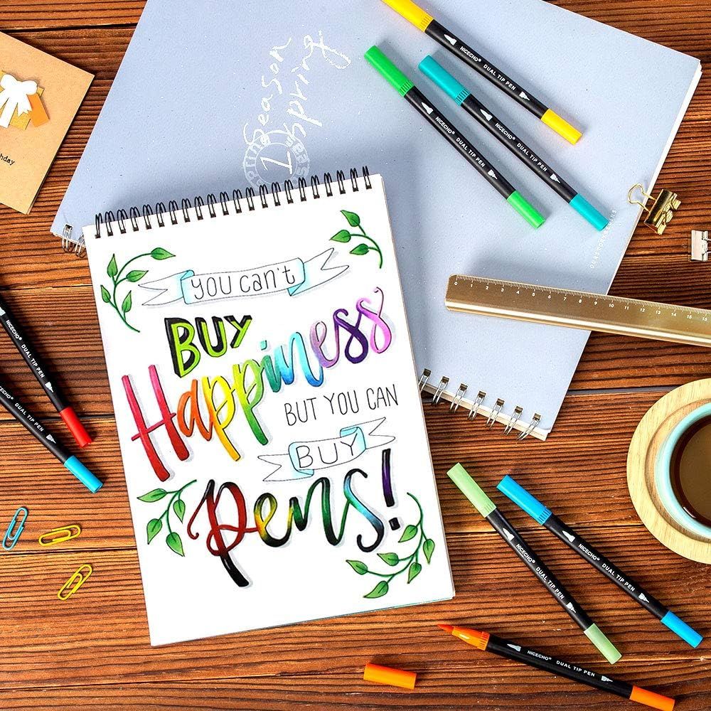 Demonstrates the product (dual tip pens) in a real-world creative context, showing the pens being used for hand lettering and artistic work to help shoppers visualize how they might use the product…