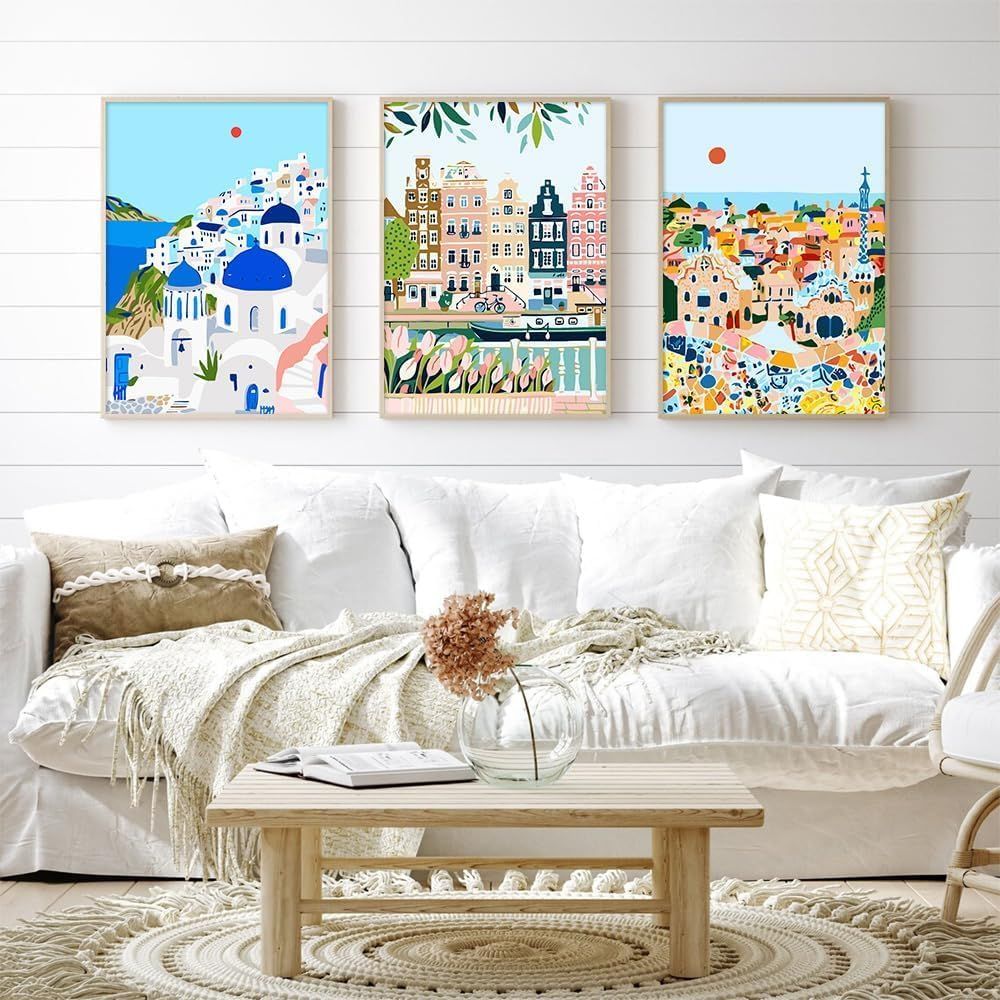 Shows the product (decorative wall art prints) styled in a real-world living room setting to help shoppers visualize how the artwork would look in their own home.