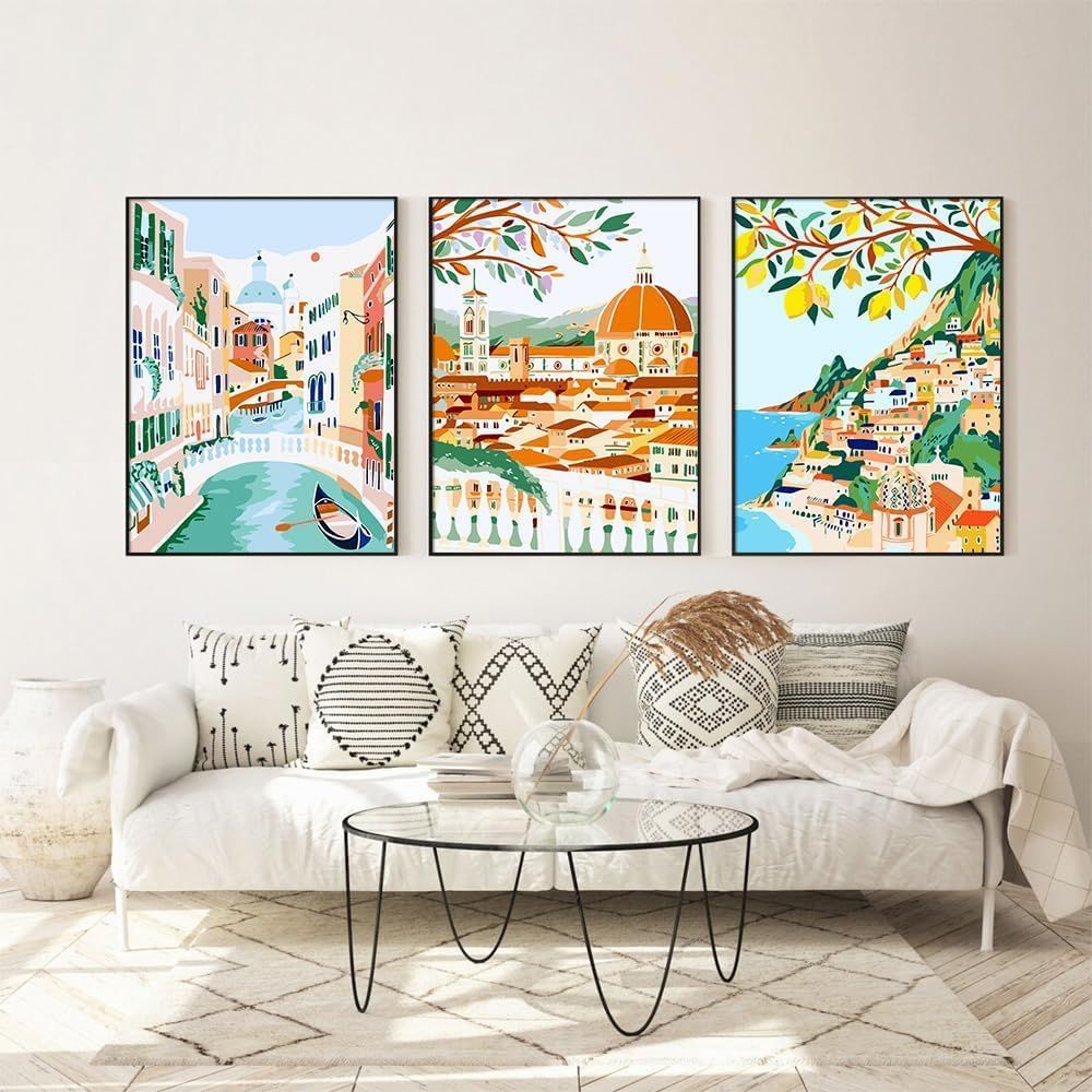 Shows the product (decorative wall art prints) styled in a real-world living room setting to help shoppers visualize how the artwork would look in their own home.